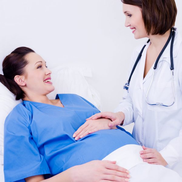 pregnant woman with doctor in maternity hospital before childbirth